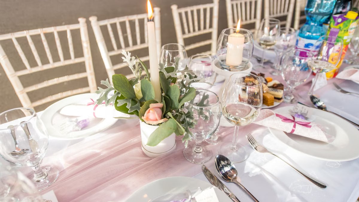 Beautifully arranged dining table for an elegant occasion with floral centerpiece and candles.